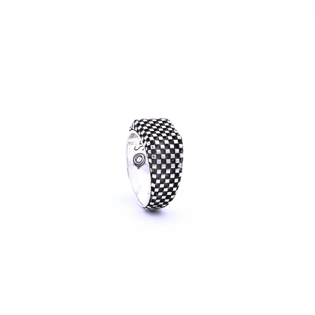 A silver ring with a checkerboard pattern.